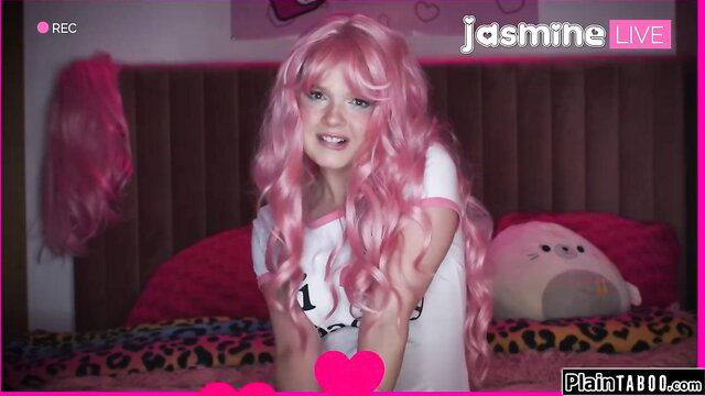 Coco Lovelock in pink wig smiling on cam stream, sexy white top
