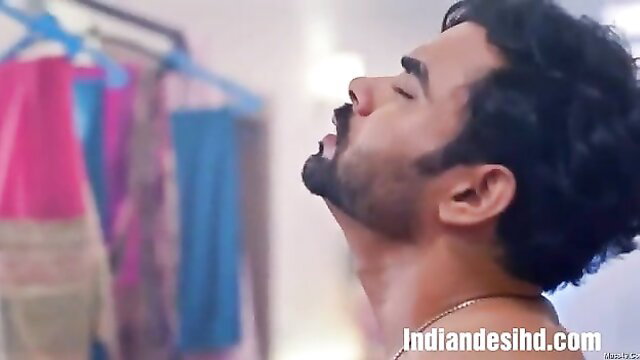 Handsome Indian man with curly hair and beard exhales passionately in Jaal web series