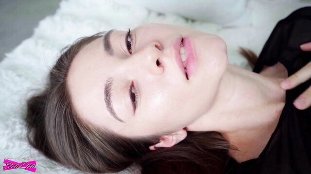 SolaZola seductive closeup, sultry gaze and parted lips on white fur