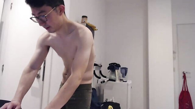 Fit Asian emo twink flexing shirtless in grey pants, lean abs
