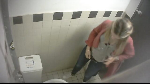 Blonde woman peeing in toilet filmed from above in bathroom