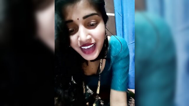 Anupama Jhoshii smiling Indian cam girl in turquoise saree blouse