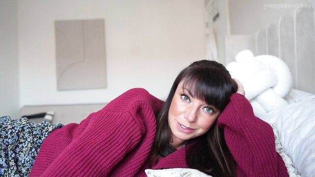 Yourgirlnextdoor1 in red sweater, seductive pose on bed as birth step-mom