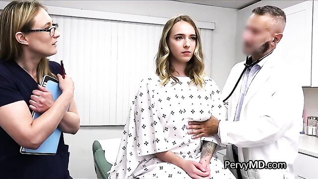 Blonde busty patient in gown examined by doctor as nurse watches
