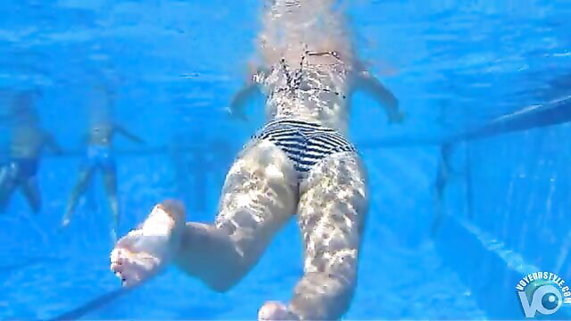 Hot girl in striped bikini swims underwater, sexy wet ass view