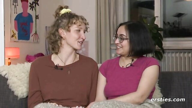Jasmina and Serafina chat smiling on couch in cozy room