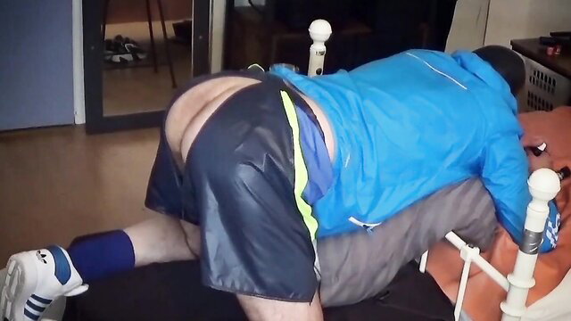 Britt twink in adidas nylon cut-offs bent over bed for faux-cock bang