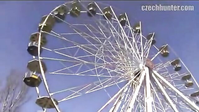 Ferris wheel spinning at fairground with CzechHunter watermark