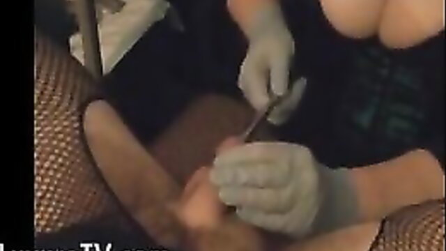 Hot nurse in latex gloves sounding bound man's cock with rod