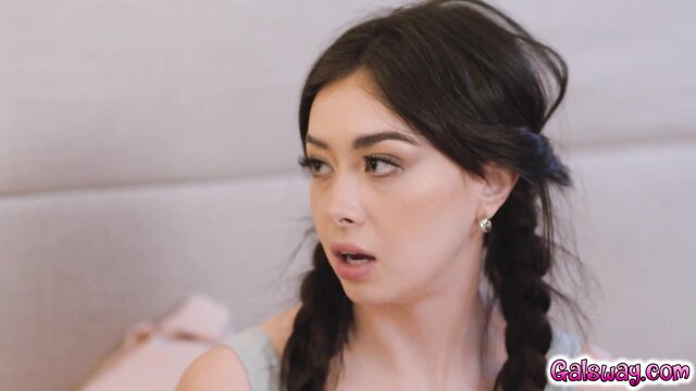 Asian babe with pigtails in off-shoulder top, surprised expression