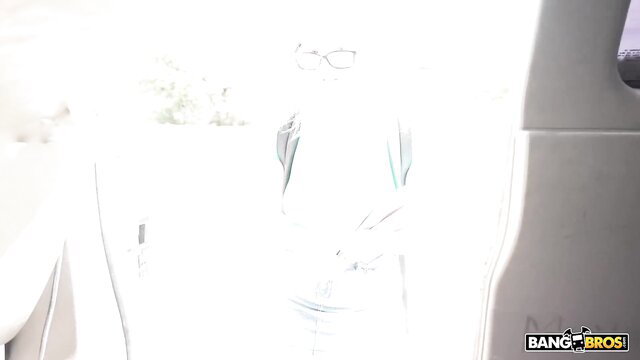 Nerdy blonde in glasses kneels by car window for POV blowjob