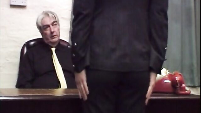 Mature saleslady in suit bent over desk for leather belt spanking punishment