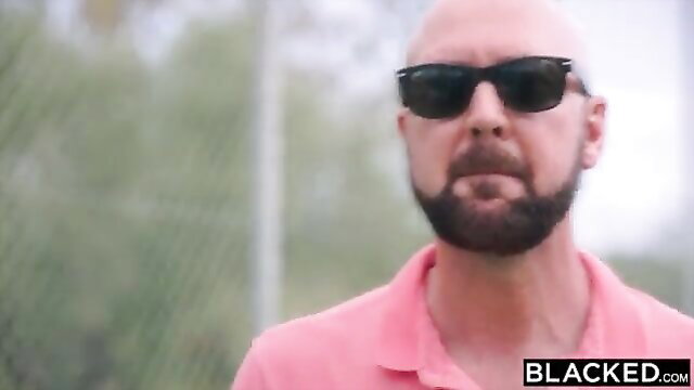 Bald bearded white man in pink shirt smirks outdoors on Blacked