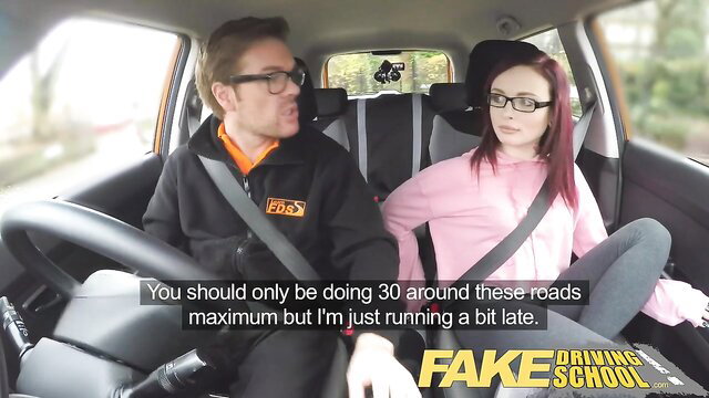Chloe Carter in pink hoodie with British instructor in Fake Driving School car