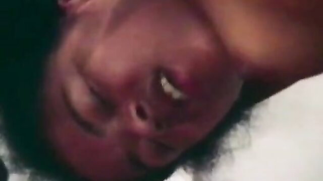 Upside-down closeup of smiling black schoolgirl in classic porn thumbnail