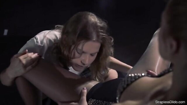 Domineering mistress in heels dominates schoolgirl in lesbian strapless dildo play