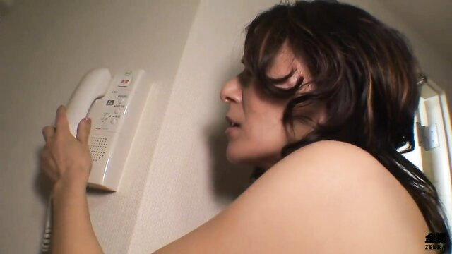 Nude Japanese MILF on phone, bare tits exposed, seductive glance