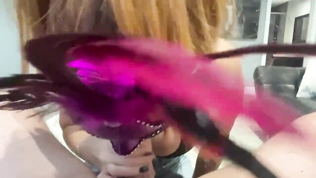Hot blonde with purple feather boa gives teasing blowjob in Halloween tease