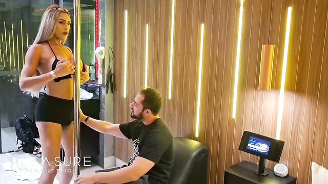 Blonde bombshell stripper teases guy in bra and shorts by pole