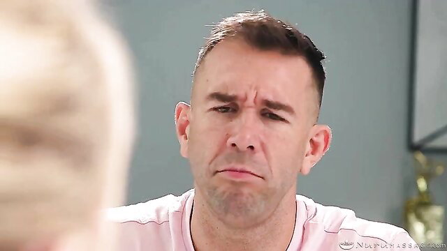 Closeup of mature man's puzzled face in pink shirt from adult video thumbnail