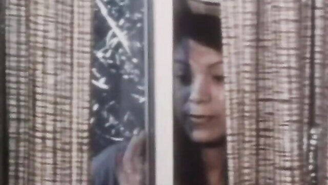 Vintage Asian woman peeking seductively through broken window curtains