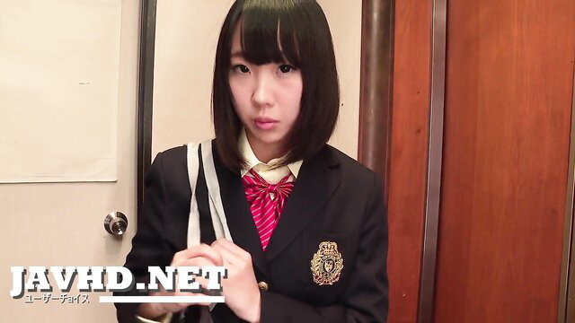 Cute Japanese schoolgirl in blazer and skirt poses seductively