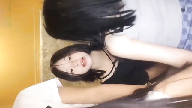 Asian teen in lingerie practices intensely on bed, sweaty erotic pose