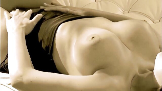 Aria Giovanni's big tits exposed, glamorous Latina nude on couch