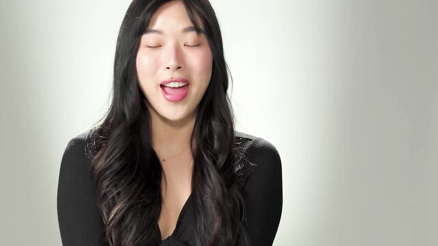 Hot Korean teen Elle Lee smiling with tongue out, teasing closeup