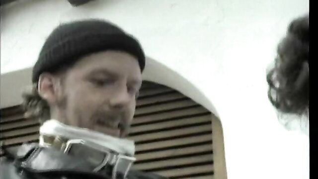 Man in neck brace and beanie in kinky collar scene from classic Ribu Aristokrat 50