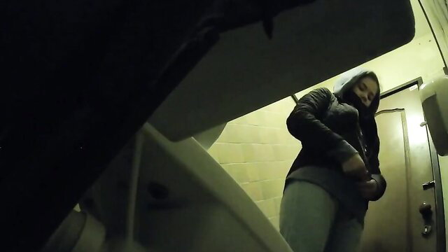 Amateur spy cam of hooded Latina in leather jacket pulling down pants in cafe toilet
