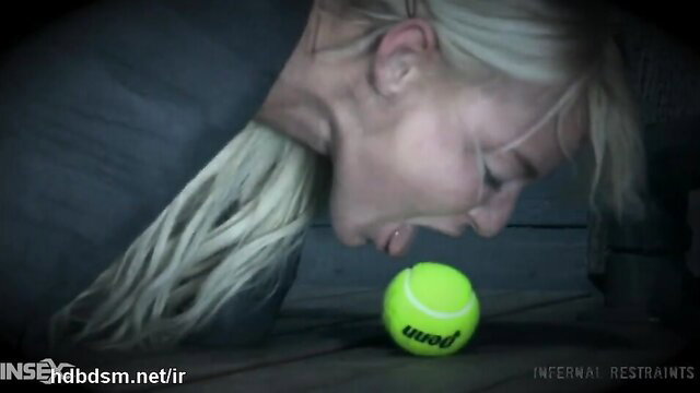 Submissive blonde with big tits kneels for tennis ball in BDSM scene