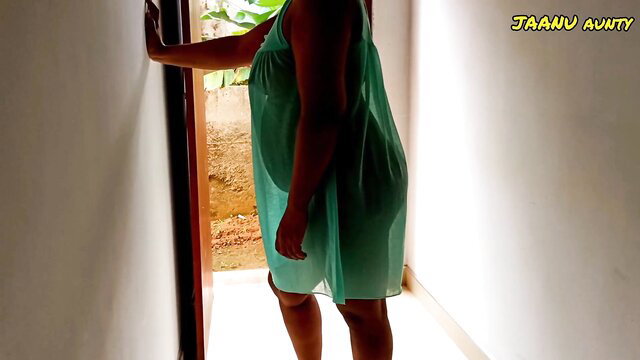 Curvy Indian Hot Aunty Jaanu in sheer green dress at door