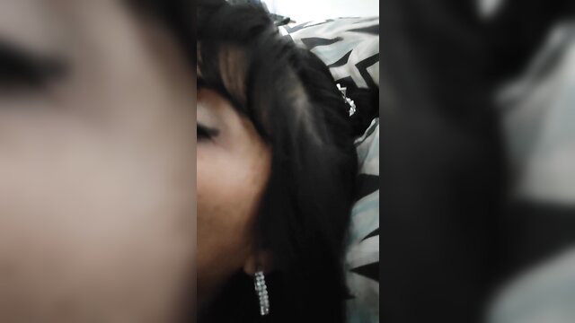 Closeup of seductive black woman's face with long dark hair and sparkling earrings