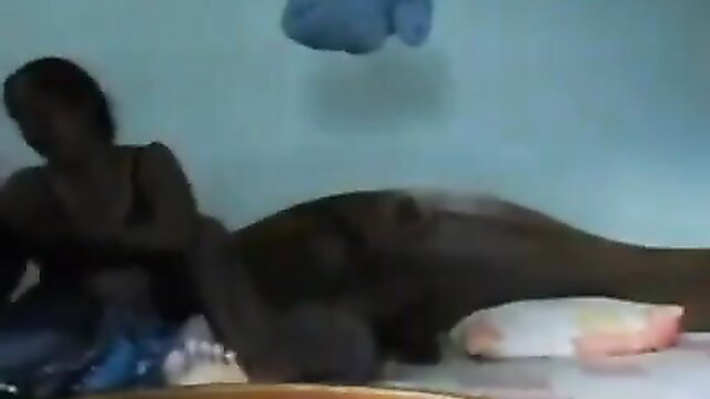 Ebony woman lying nude with baby on bed in Sri Lankan amateur video