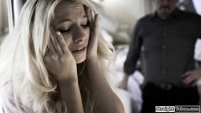 Blonde babe distressed face palms head, man behind in taboo spank scene