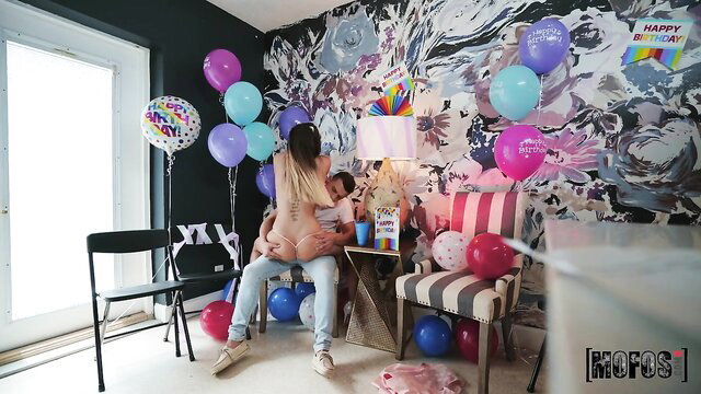 Blonde party girl nude lap dance with man at colorful birthday bash