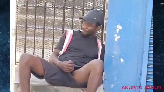 Black street boy cruising solo, grabs huge cock in shorts by gate