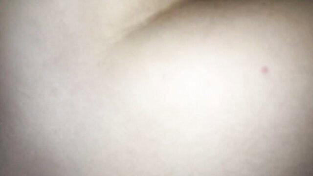 Blurry closeup of pale skin and small red mark on amateur girl's butt