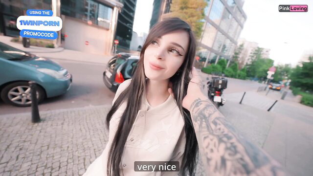 Pinkloving tattooed Asian beauty smiles teasingly in public street POV