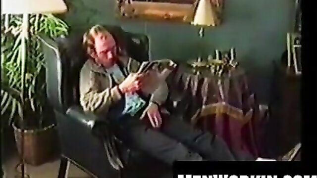 Hairy Gene reclining in chair reading, amateur gay solo tease