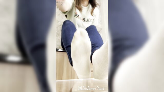 Asian girl POV white socks feet up close in tight jeans