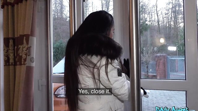 Lexi Dona in white fur coat at door, long black hair