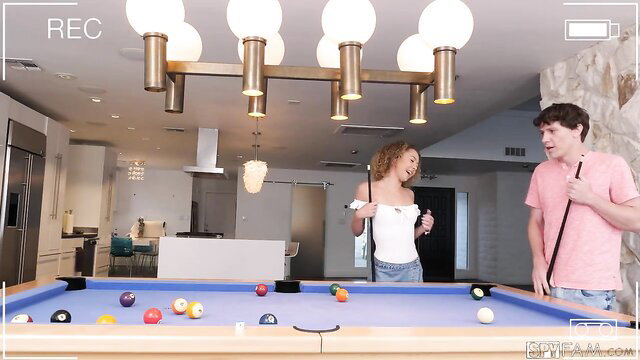 Curly-haired black teen slut in white top bends over pool table for young guy