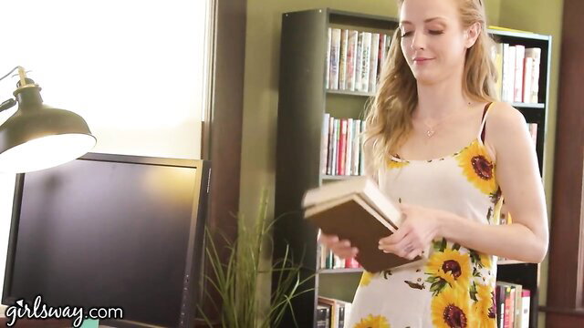 Karla Kush in sundress reading book at library, Penny Pax nearby