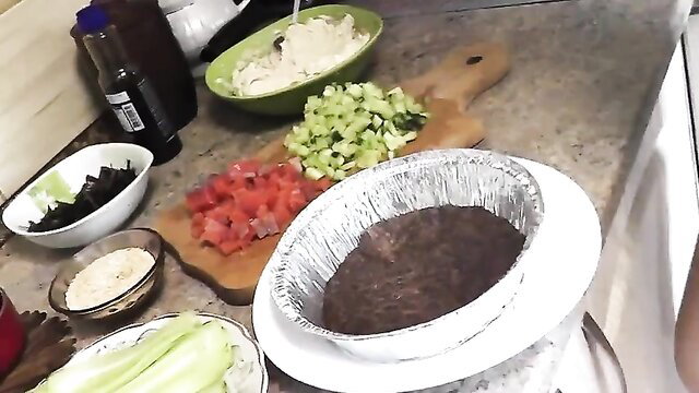 Naked blonde MILF Frina preps food nude in kitchen