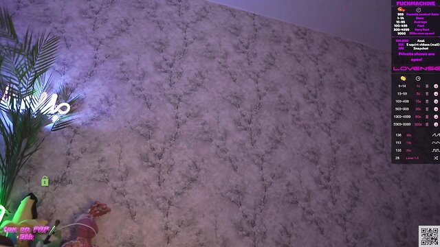 Hot streamer in neon-lit room teases with green toy and skimpy outfit on cam