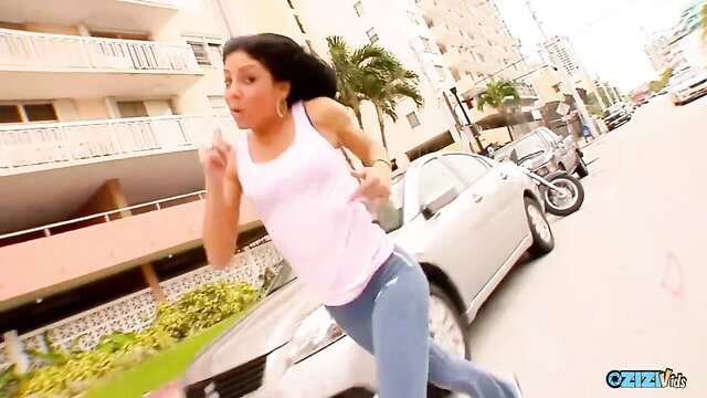 Latina woman in tight tank top and leggings running on sunny street