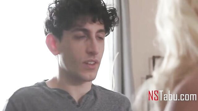 Step mom with blonde hair chats intimately with curly-haired young guy