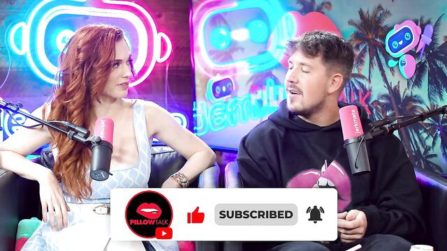 Lauren Phillips redhead in sheer top on podcast set with male co-host